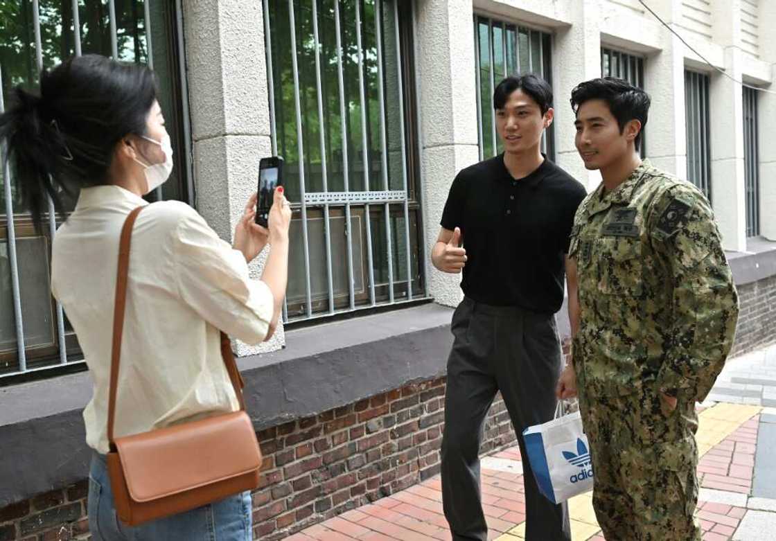 Former South Korean Navy SEAL turned YouTuber Ken Rhee (R) poses for a photo with a fan on a street in Seoul Former South Korean Navy SEAL turned YouTuber Ken Rhee (R) poses for a photo with a fan on a street in Seoul