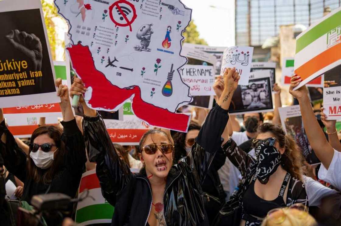 Protesters hold banners as they take part in a rally outside the Iranian consulate in Istanbul on September 29, 2022 Protesters hold banners as they take part in a rally outside the Iranian consulate in Istanbul on September 29, 2022