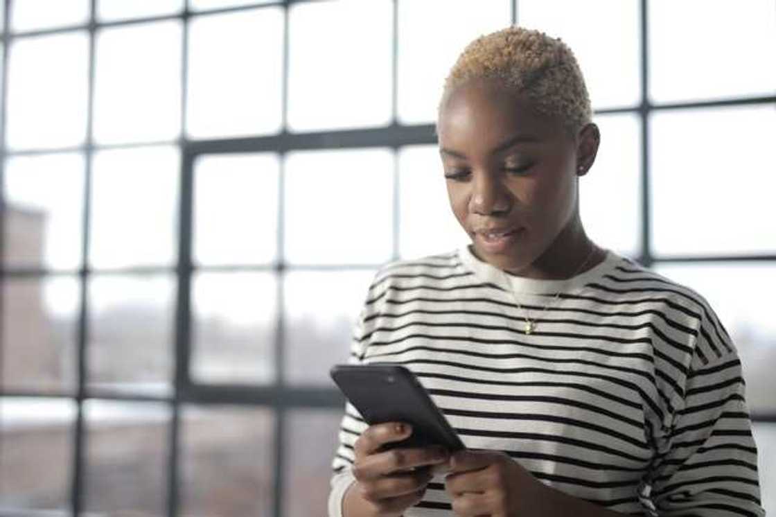 A student checking her results on the phone.