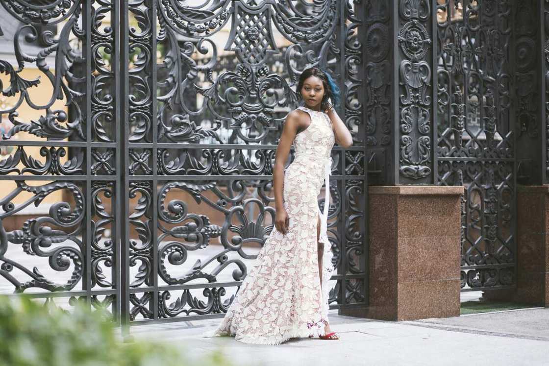 A woman wearing white floral sleeveless gown