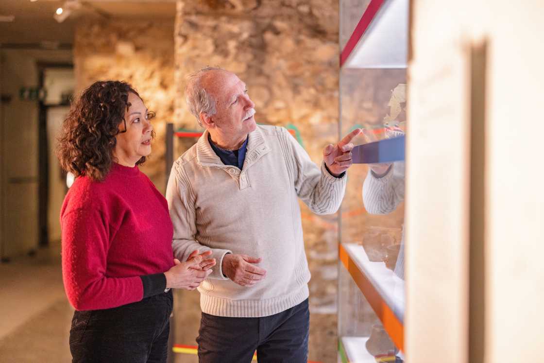 A senior couple at a history museum during the weekend. A senior couple at a history museum during the weekend.