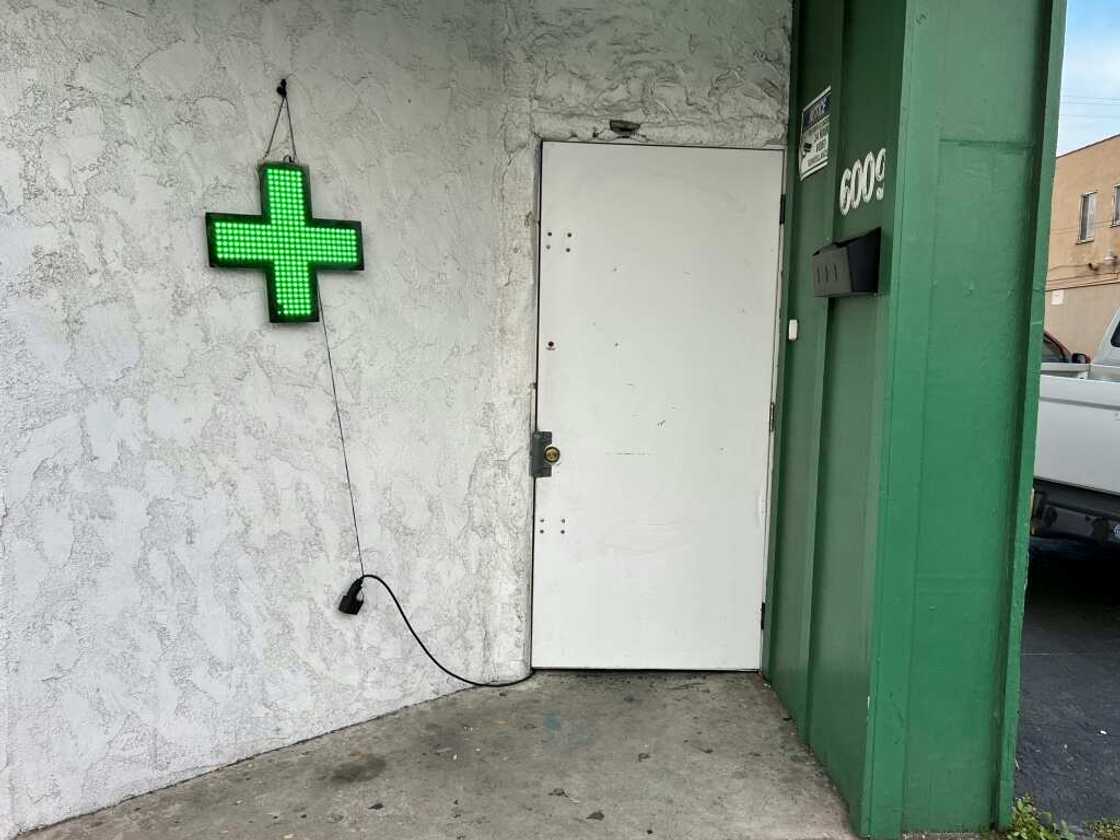 Unlicensed cannabis stores sometimes display a green cross Unlicensed cannabis stores sometimes display a green cross