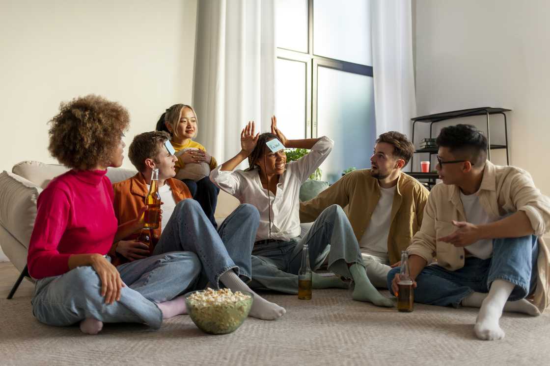 A group of young friends playing charades. A group of young friends playing charades.