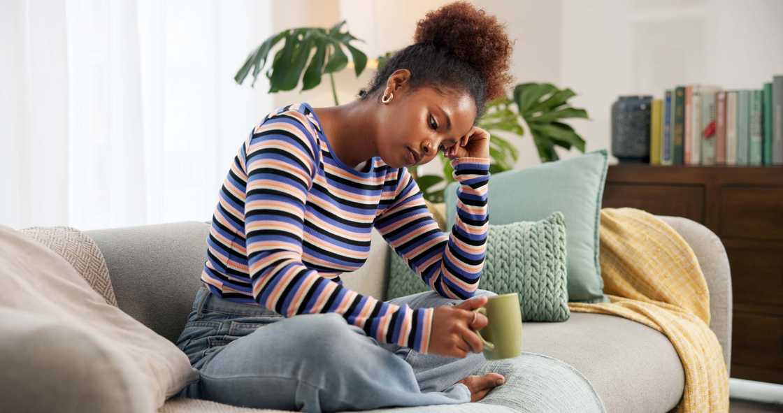 A sad lady holds a cup of coffee A sad lady holds a cup of coffee