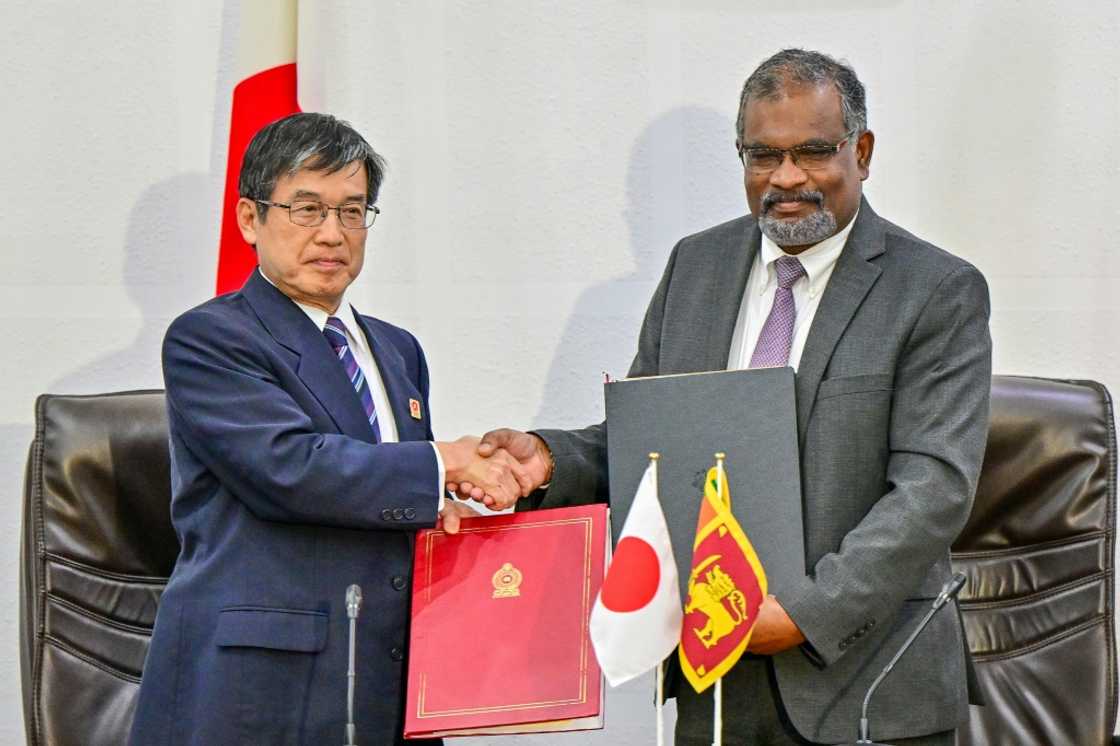 Japan's ambassador to Sri Lanka Akio Isomata (left) with Sri Lanka finance ministry secretary Mahinda Siriwardana after signing the debt restructuring agreement Japan's ambassador to Sri Lanka Akio Isomata (left) with Sri Lanka finance ministry secretary Mahinda Siriwardana after signing the debt restructuring agreement
