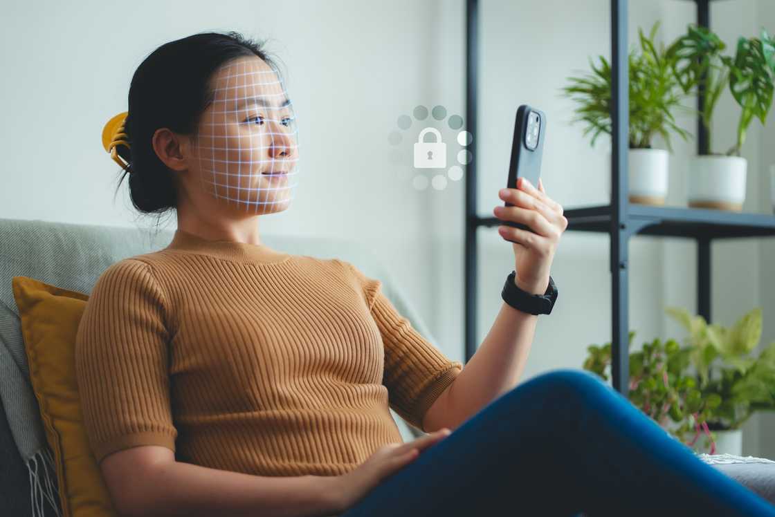 A woman scanning Face ID using a smartphone A woman scanning Face ID using a smartphone
