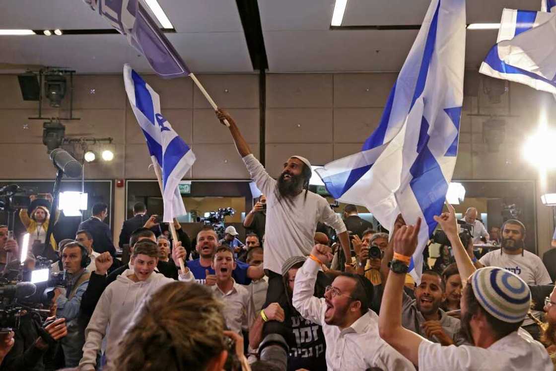 Supporters of Israel's Otzma Yehudit (Jewish Power) far-right party cheer at campaign headquarters after the end of voting on Tuesday Supporters of Israel's Otzma Yehudit (Jewish Power) far-right party cheer at campaign headquarters after the end of voting on Tuesday