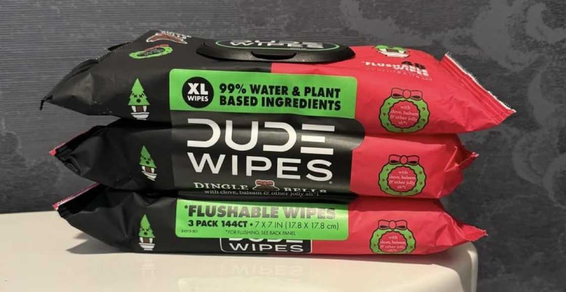 Three packets of Dude Wipes on the toilet