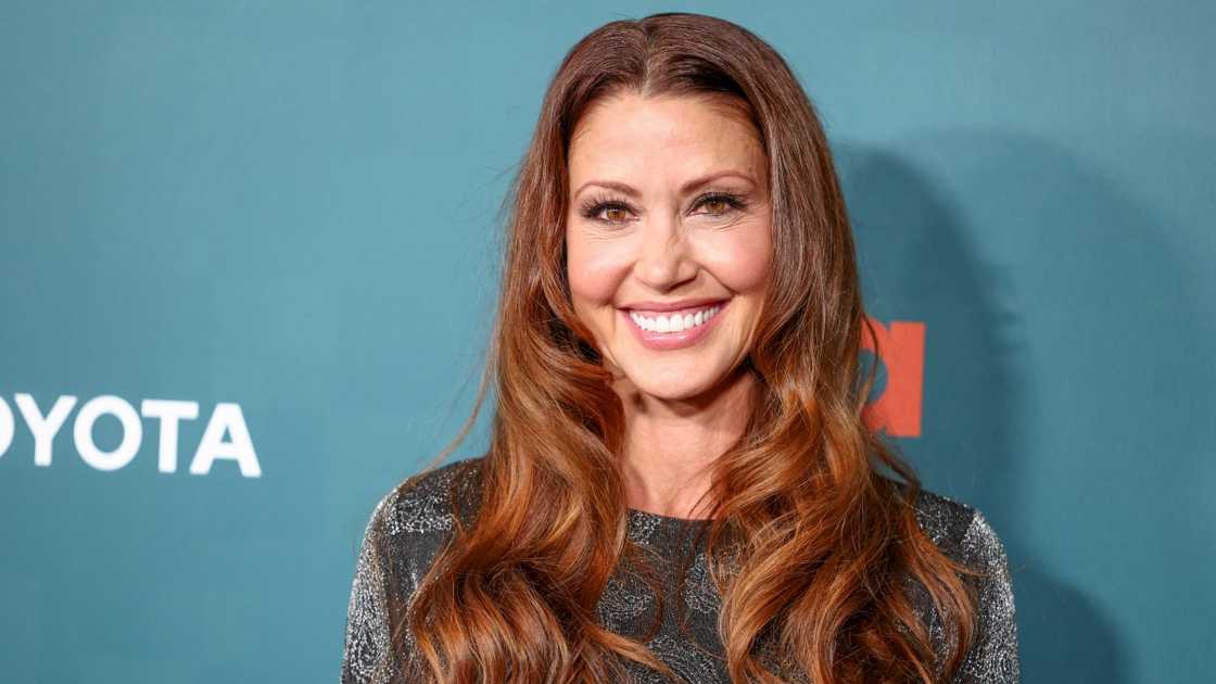 Shannon Elizabeth poses standing in a silver outfit on the red carpet of the 33rd Annual EMA Awards Gala