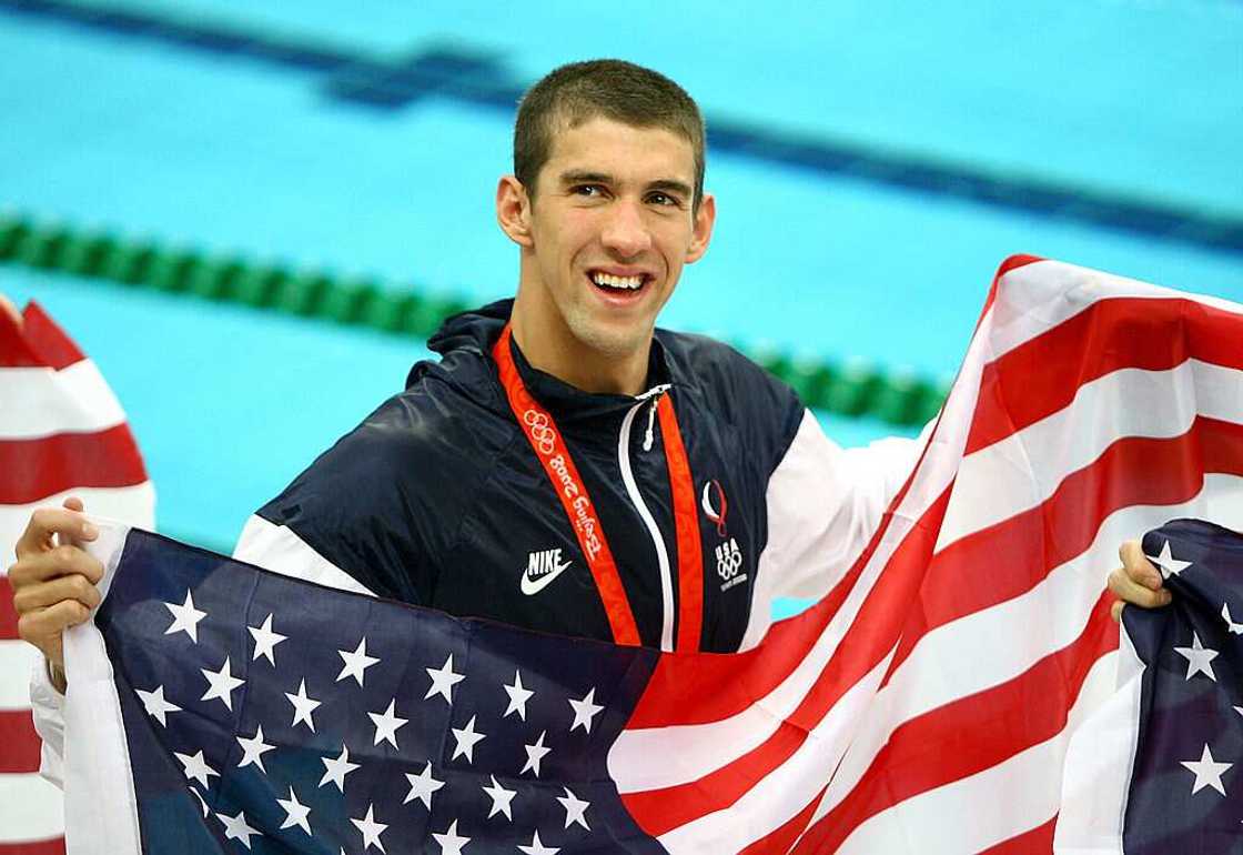 Michael Phelps of the United States smiles as he wears his eighth gold medal