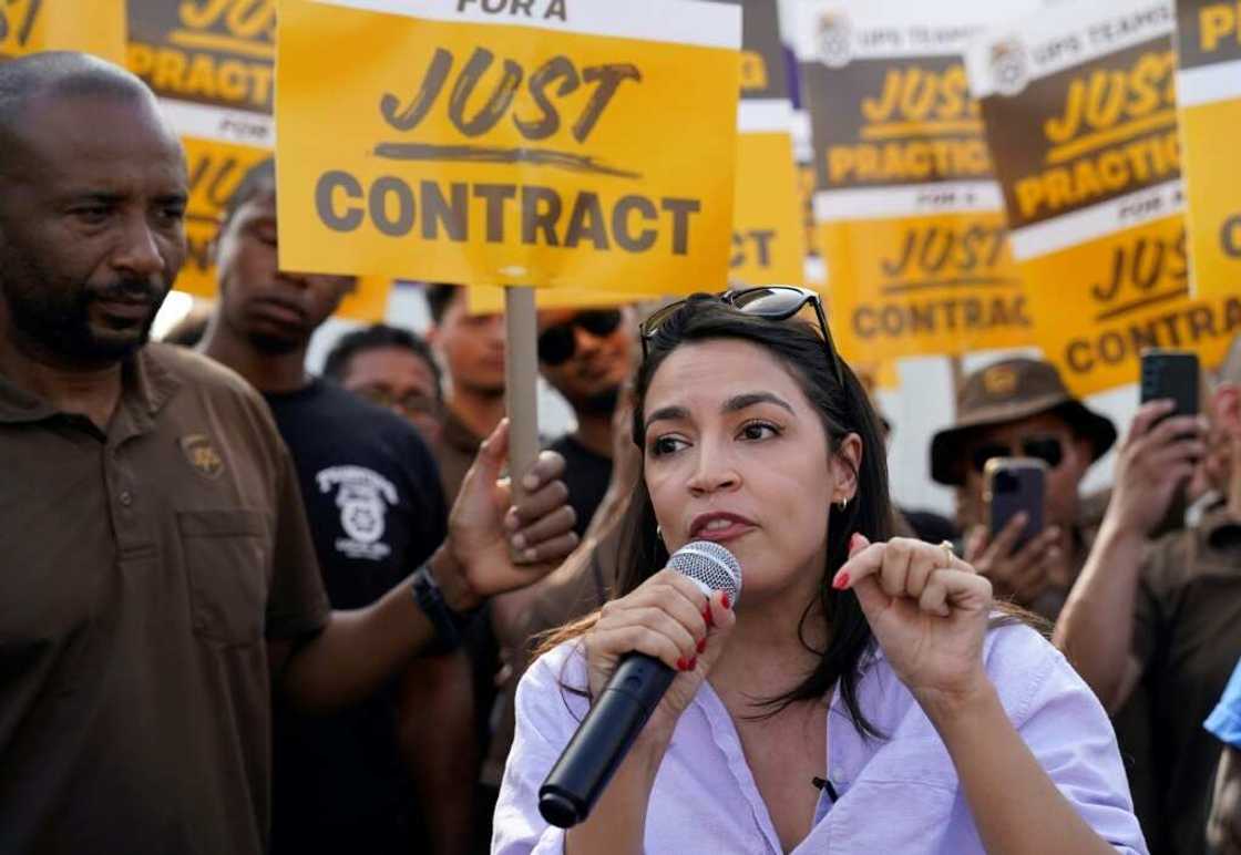 US Representative Alexandria Ocasio-Cortez, Democrat of New York, speaks to United Parcel Services (UPS) workers during a 'practice picket line' on July 7, 2023, in the Queens borough of New York City, ahead of a possible UPS strike US Representative Alexandria Ocasio-Cortez, Democrat of New York, speaks to United Parcel Services (UPS) workers during a 'practice picket line' on July 7, 2023, in the Queens borough of New York City, ahead of a possible UPS strike