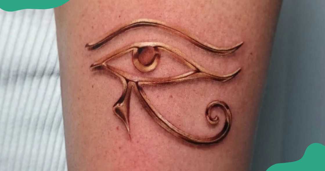 A realistic eEe of Horus tattoo in gold on the leg. A realistic eEe of Horus tattoo in gold on the leg.