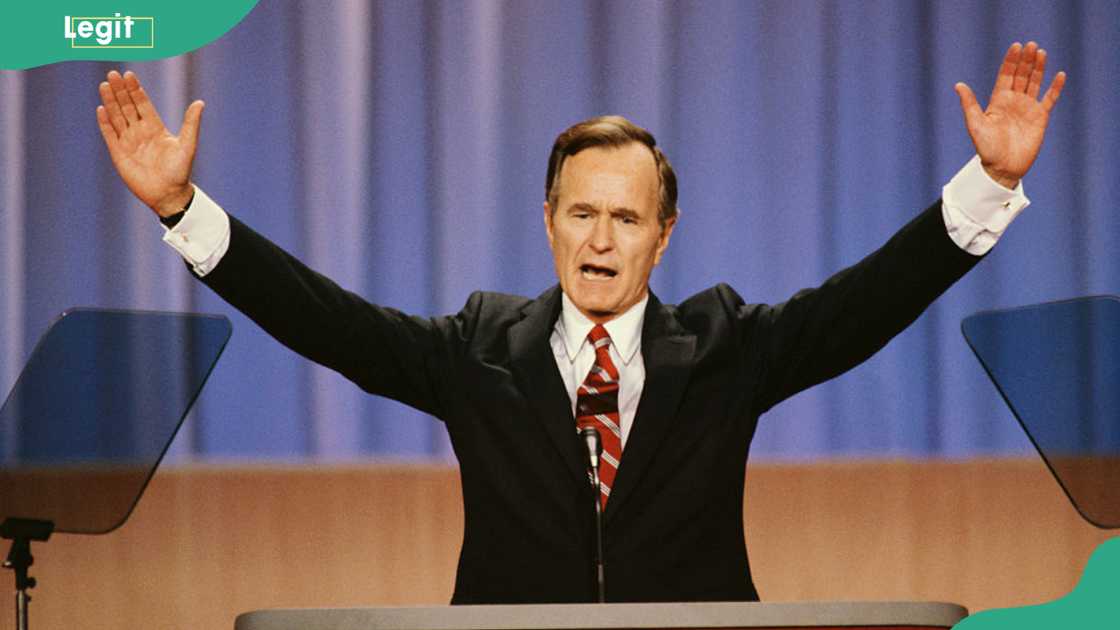 Former President George Bush raises his arms during a speech Former President George Bush raises his arms during a speech