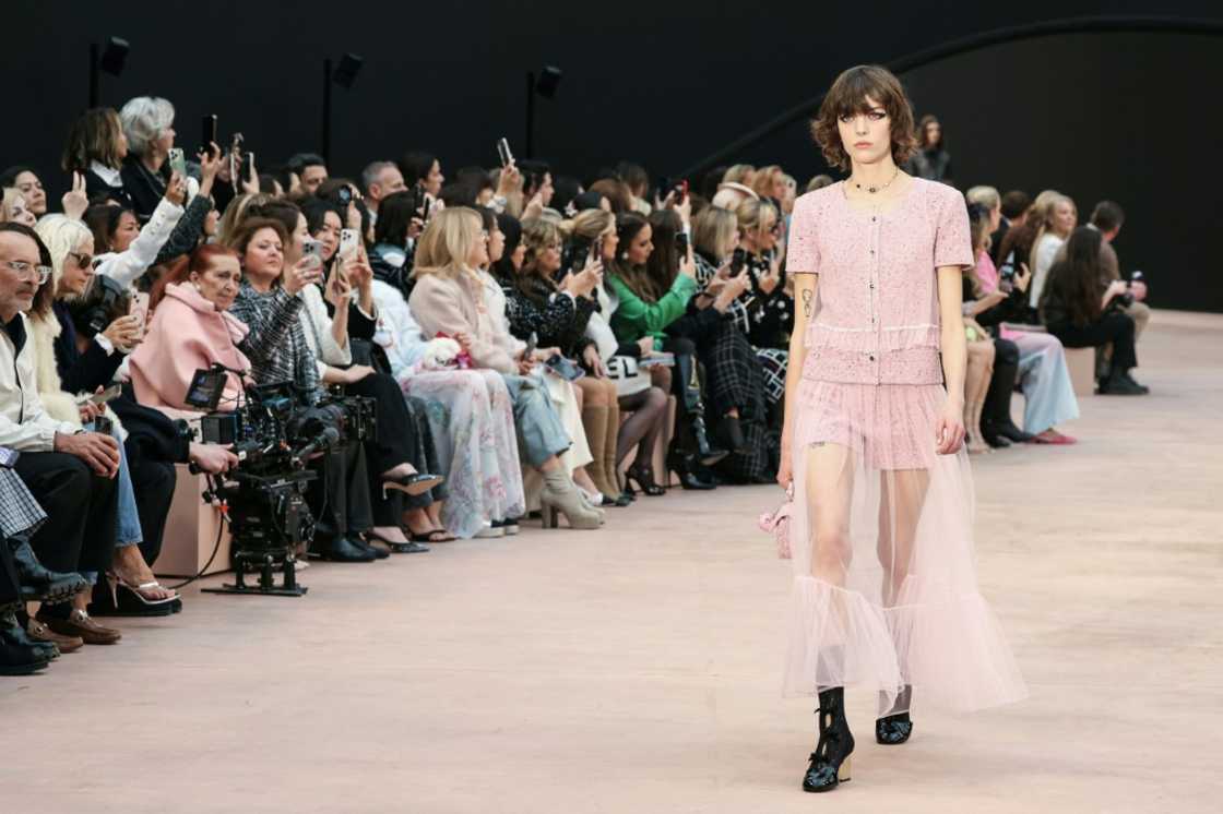 A pink tailored short ensemble was layered with a sheer jacket and matching long transparent skirt