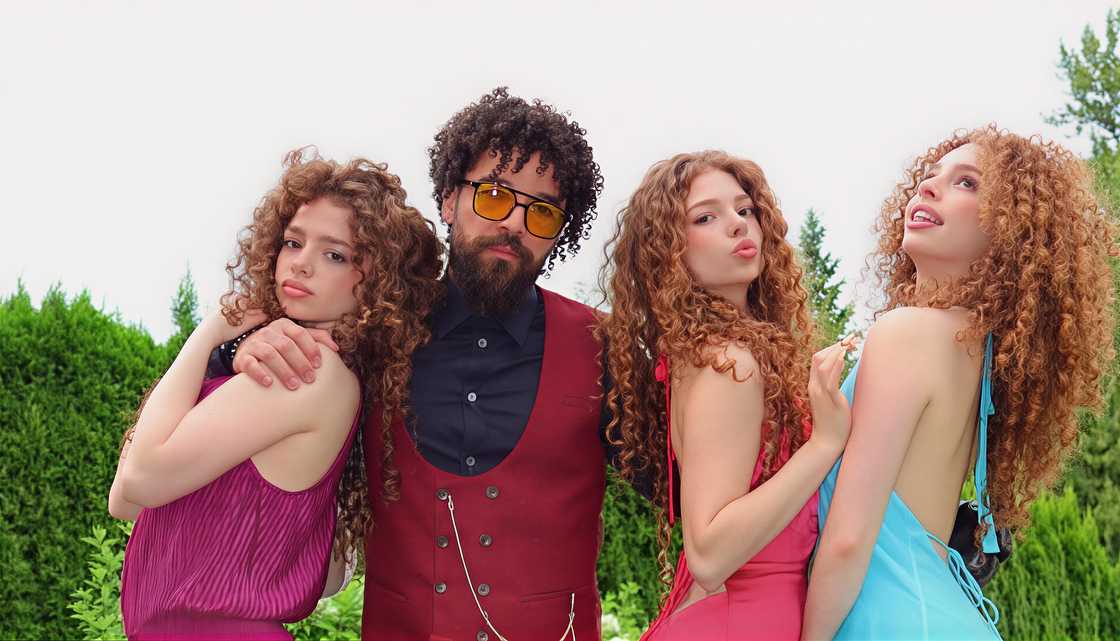 Sunday, Demitra, and Eliana pose with their father, John Kalogeras