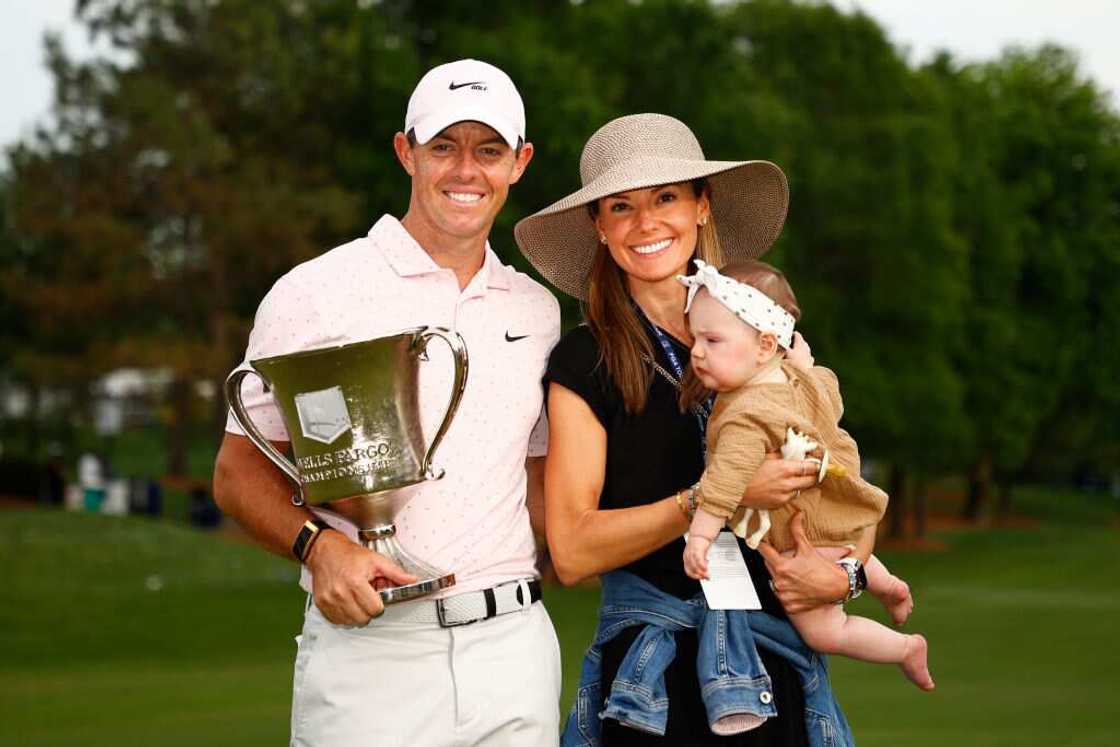 Rory McIlroy holds a trophy with his wife Erica and baby daughter Poppy