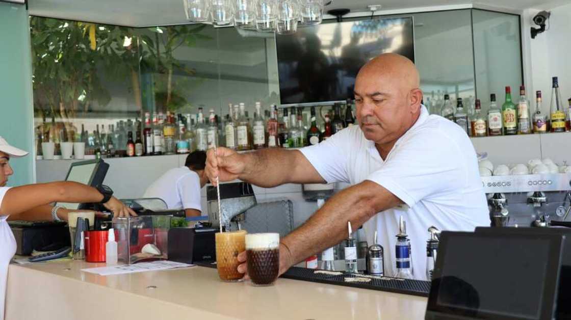 A bartender works at the Alion Beach Hotel in the Cypriot resort town of Ayia Napa. Operators had hoped this summer would see Russian tourist numbers return to pre-pandemic levels A bartender works at the Alion Beach Hotel in the Cypriot resort town of Ayia Napa. Operators had hoped this summer would see Russian tourist numbers return to pre-pandemic levels
