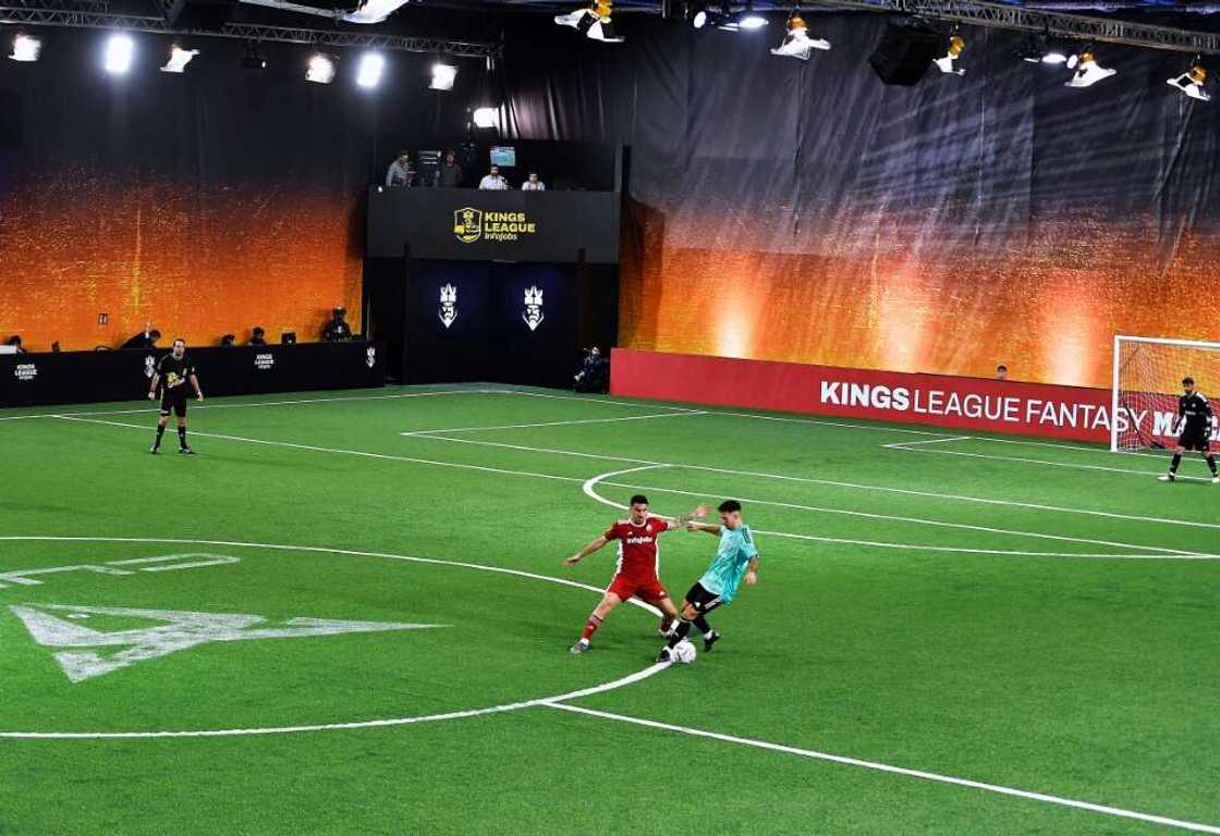 Players of Jijantes FC (L) and PIO FC teams vie for a ball on a 2 vs 2 period at the Cupra Arena stadium in Barcelona