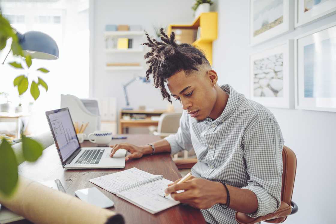 A young male accountant working from home. A young male accountant working from home.