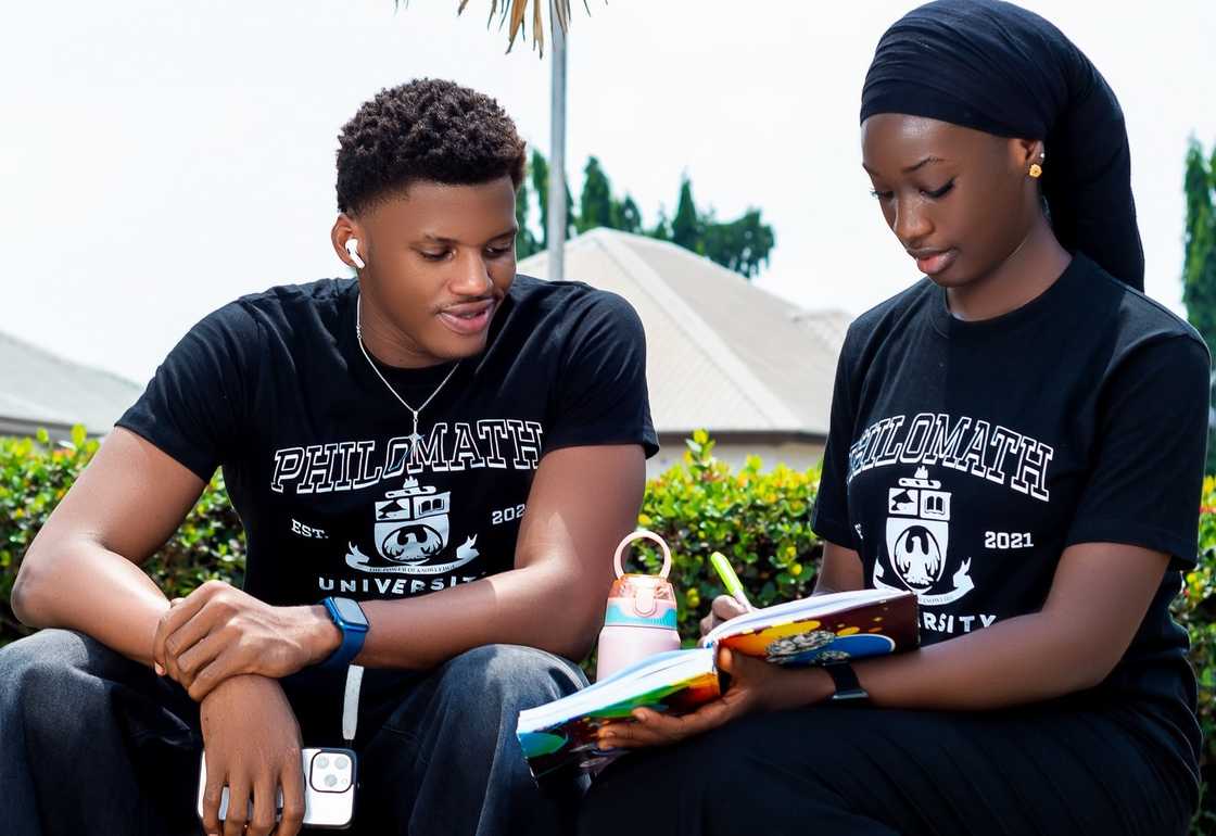 Two students at Philomath University studying outdoor Two students at Philomath University studying outdoor