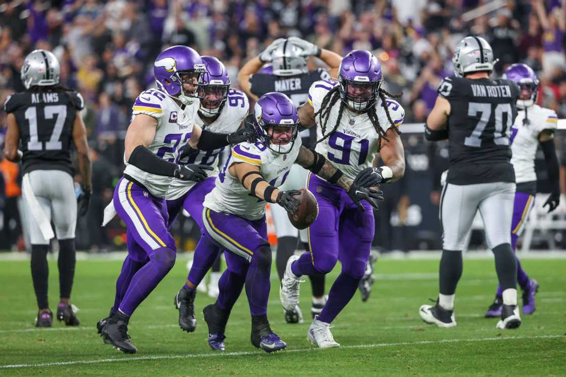 Ivan Pace Jr. of the Minnesota Vikings celebrates with teammates after making an interception at Allegiant Stadium