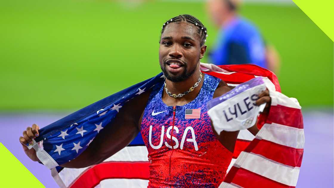 Noah Lyles flies the USA flag after winning Paris 2024 Olympics gold medal. Noah Lyles flies the USA flag after winning Paris 2024 Olympics gold medal.