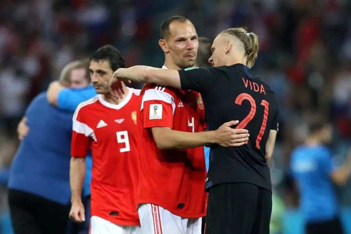 Russia's Sergei Ignashevich being consoled by Croatia's Vida after their quarterfinal exit at the ongoing World Cup. Photo Credit: Getty images Russia's Sergei Ignashevich being consoled by Croatia's Vida after their quarterfinal exit at the ongoing World Cup. Photo Credit: Getty images