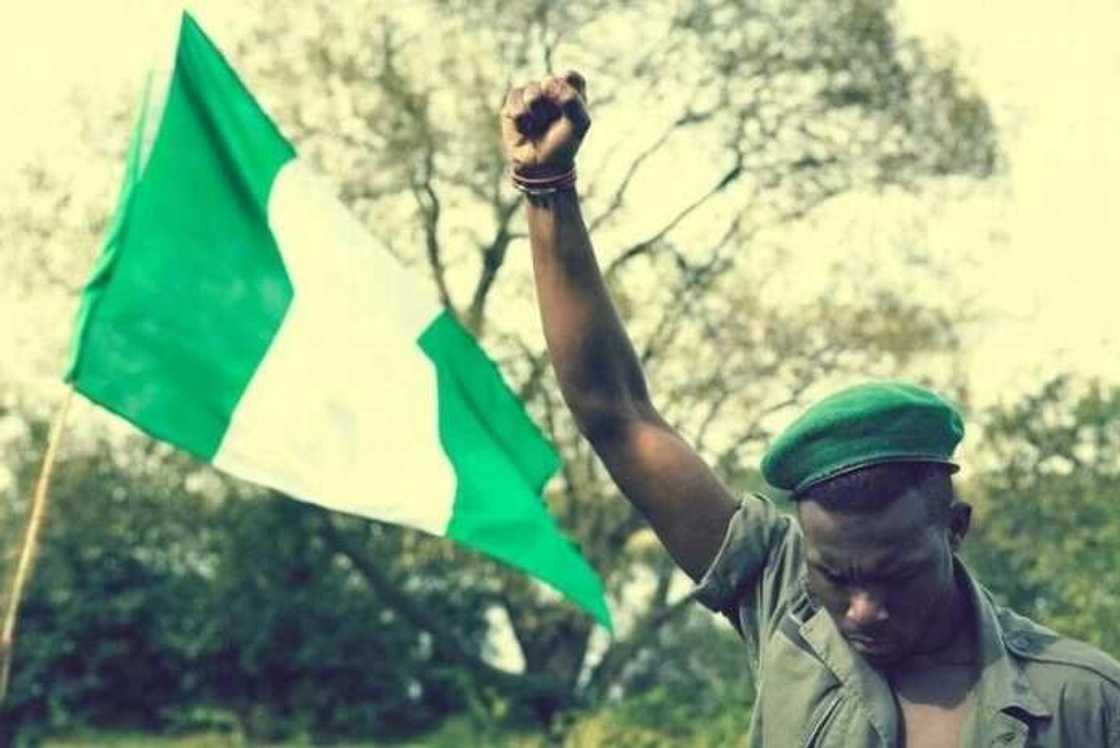 a young Nigerian man and a flag