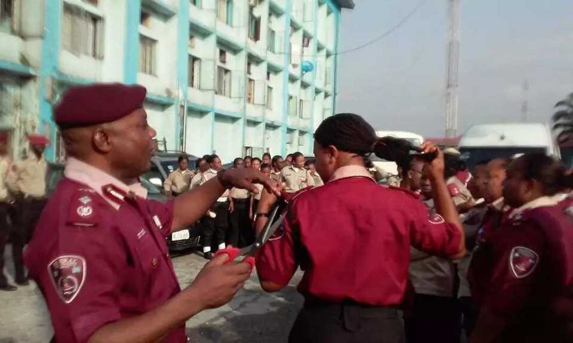 FRSC Sector Commander cutting off female officers' hairs FRSC Sector Commander cutting off female officers' hairs