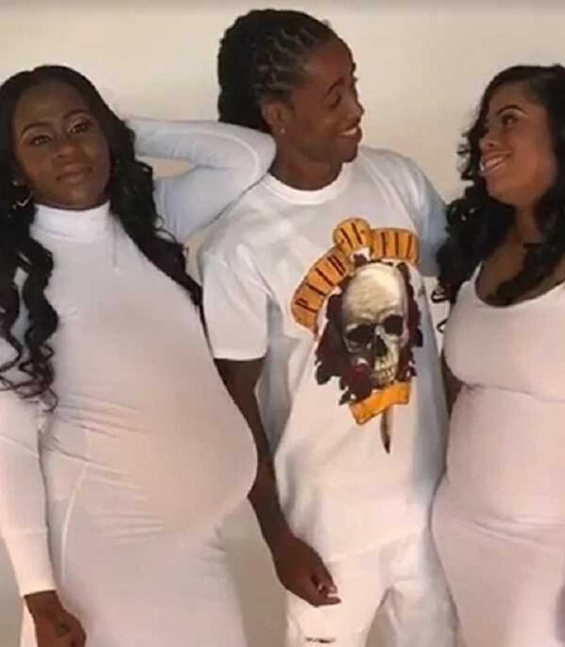 Man poses for pictures with his two pregnant girlfriends