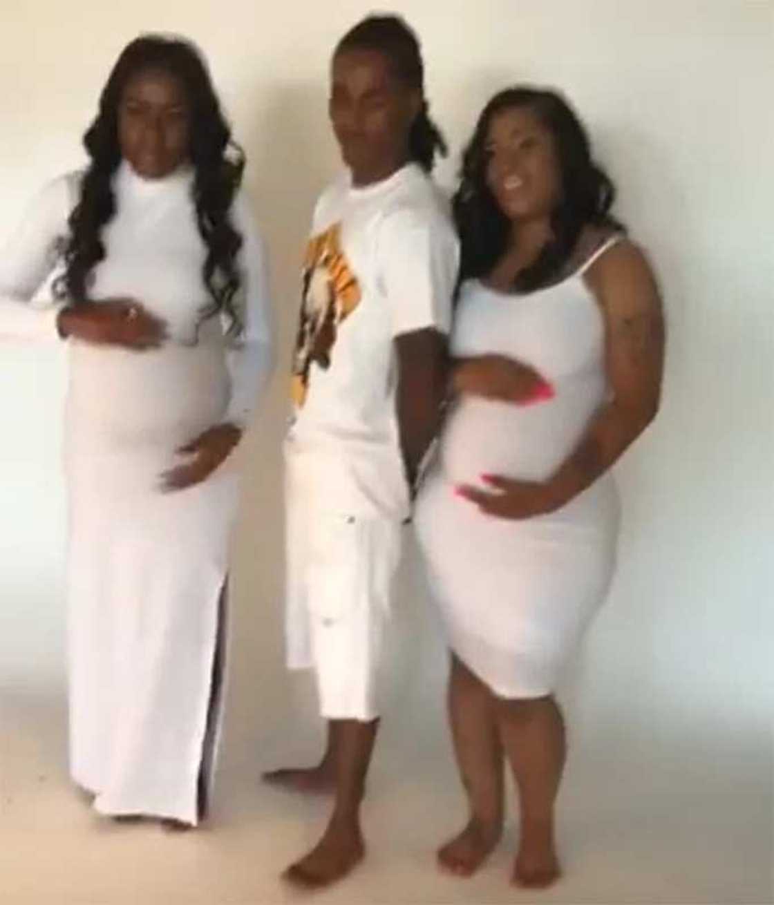 Man poses for pictures with his two pregnant girlfriends