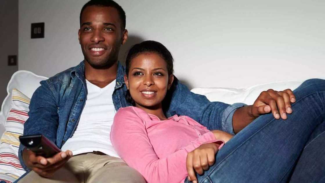 Couple watching TV together Couple watching TV together