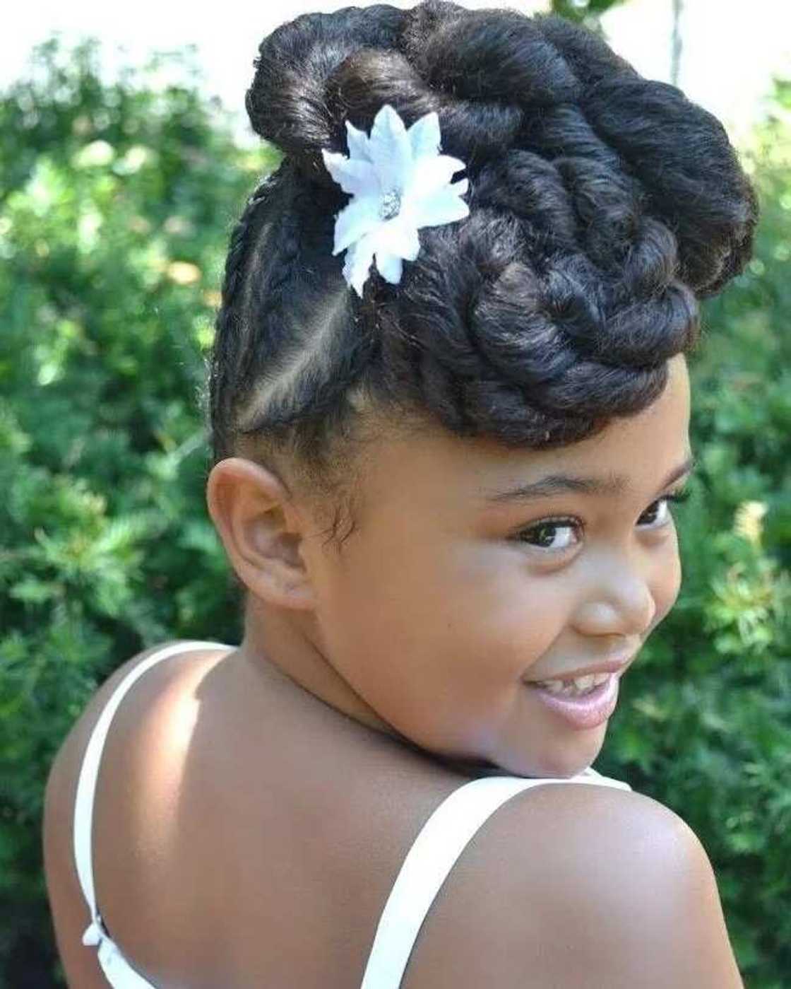 Little bride hairstyle with weaving and bun Little bride hairstyle with weaving and bun