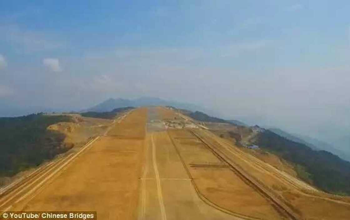 Incredible video shows Chinese workers building an airport at 5,900ft high after chopping off the top of a MOUNTAIN Incredible video shows Chinese workers building an airport at 5,900ft high after chopping off the top of a MOUNTAIN