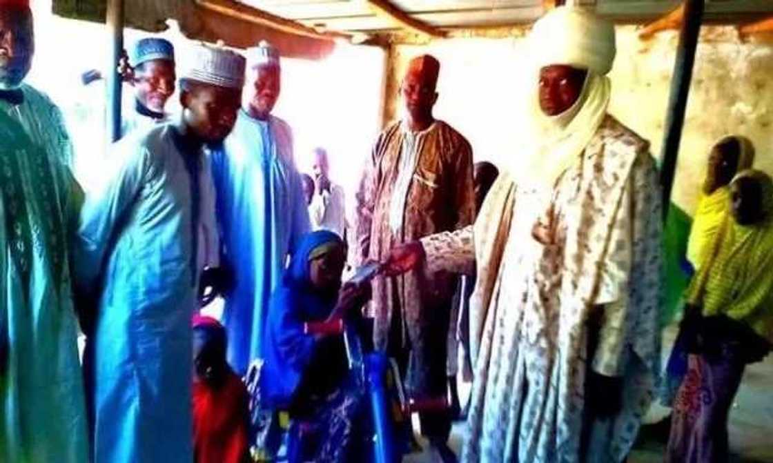 Emir of Dutse gifts wheelchair to physically challenged girl who wept after failing to get one at an event (photos) Emir of Dutse gifts wheelchair to physically challenged girl who wept after failing to get one at an event (photos)
