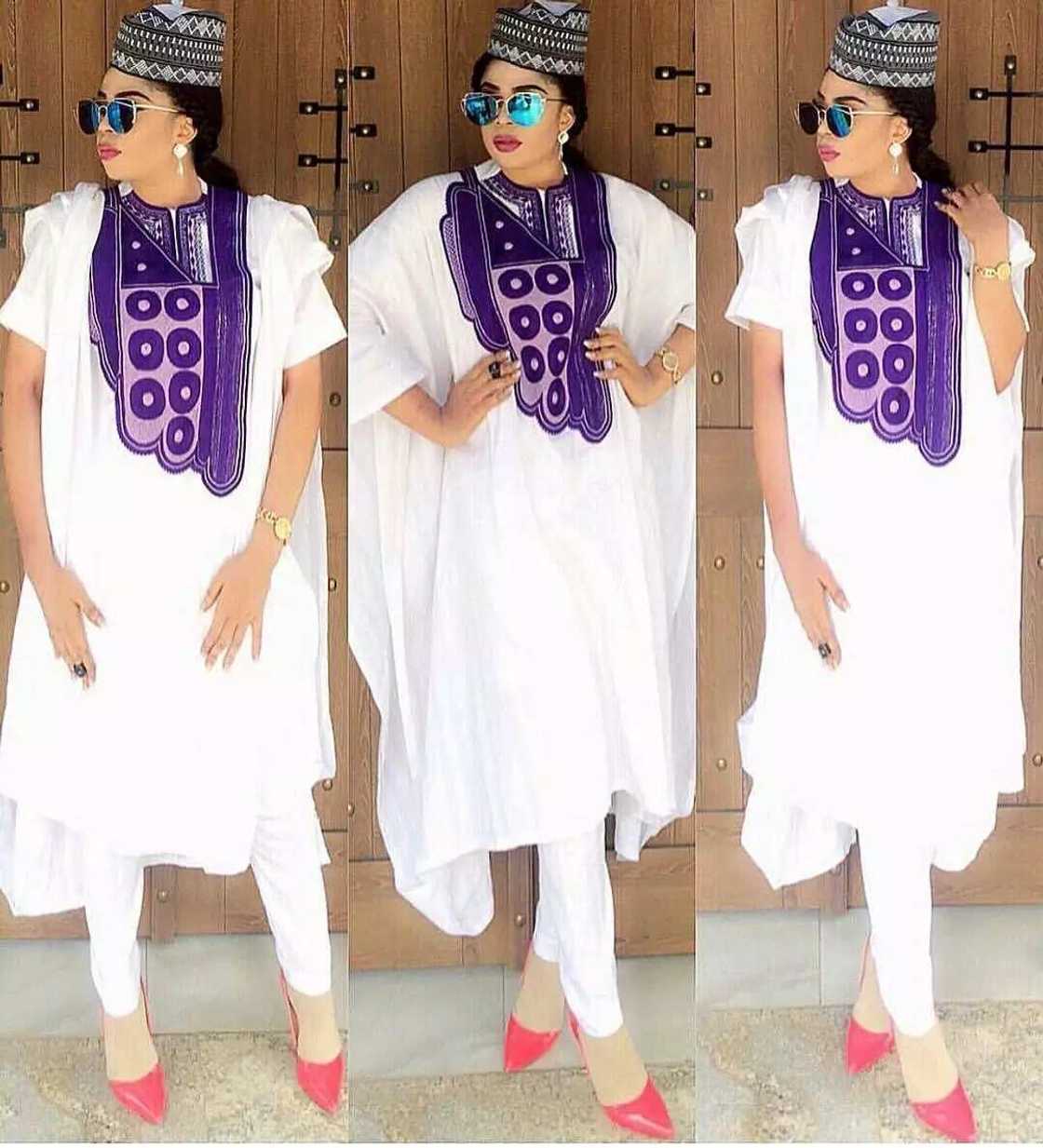 White Agbada style for ladies with lilac ornament White Agbada style for ladies with lilac ornament