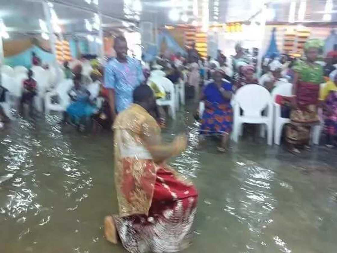 Nigerian prophet and his members worship in waterlogged church (photos) Nigerian prophet and his members worship in waterlogged church (photos)