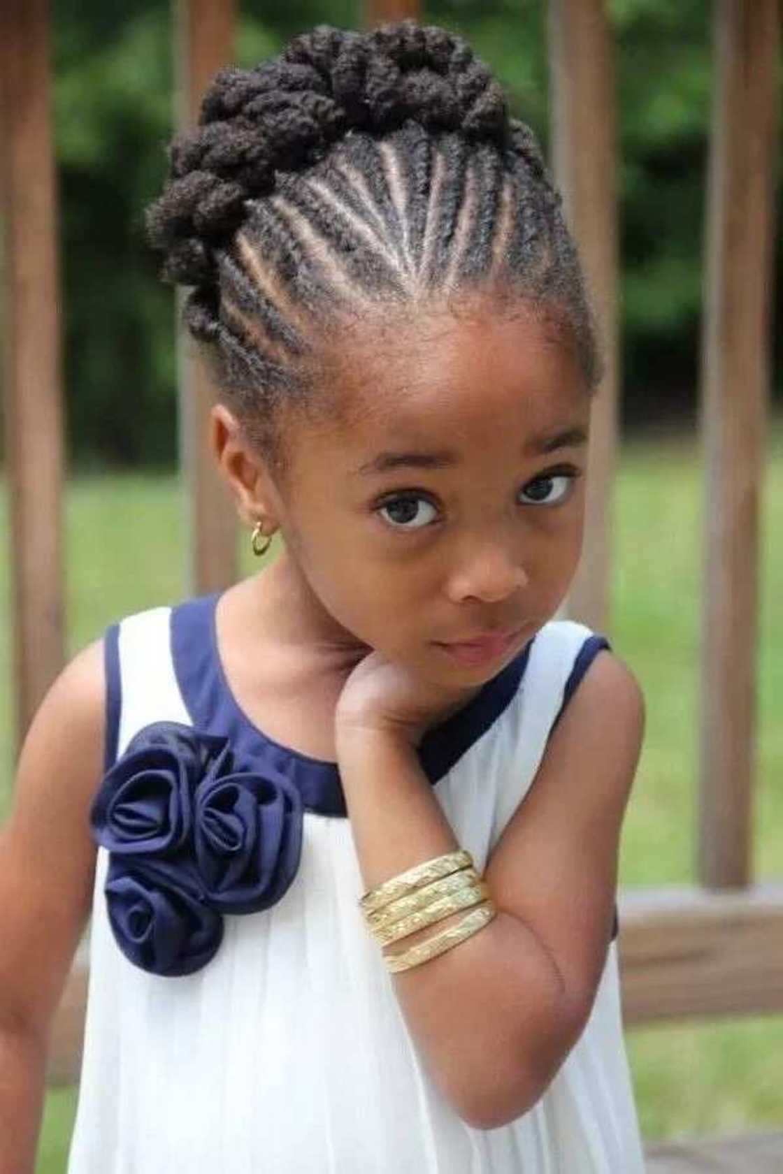 Little bride hairstyle with bun and twists Little bride hairstyle with bun and twists