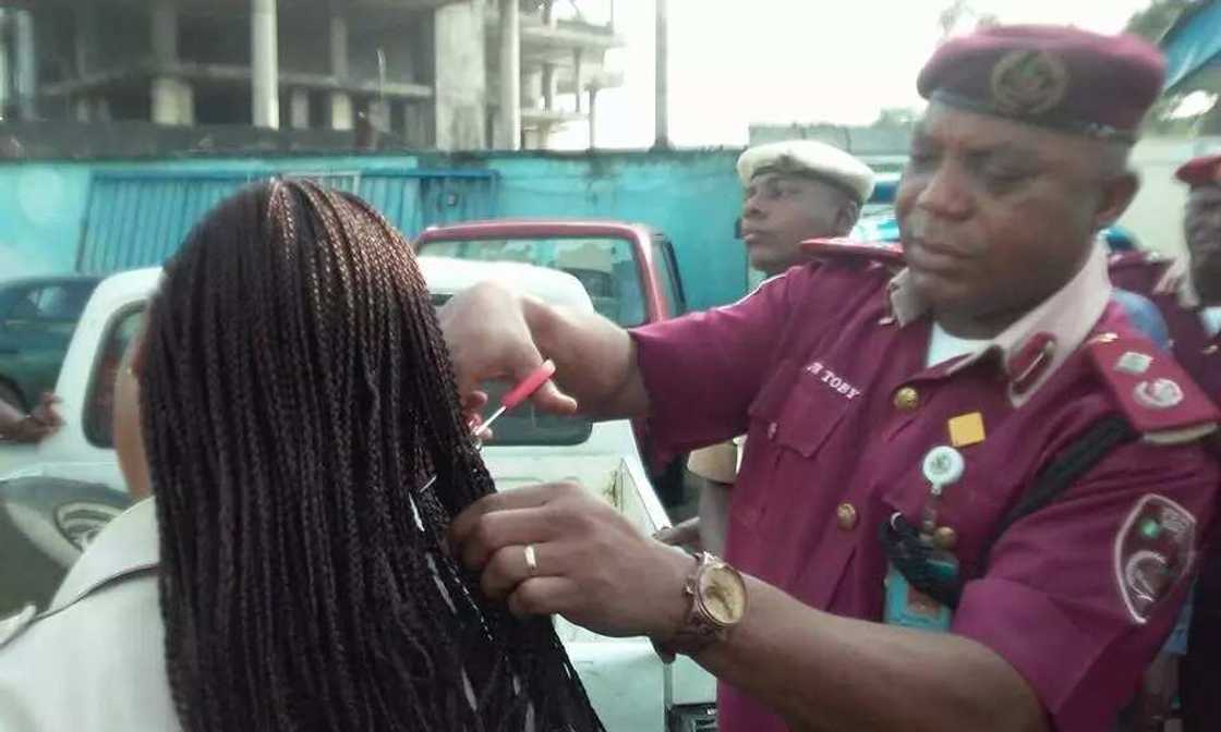FRSC Sector Commander cutting off female officers' hairs FRSC Sector Commander cutting off female officers' hairs