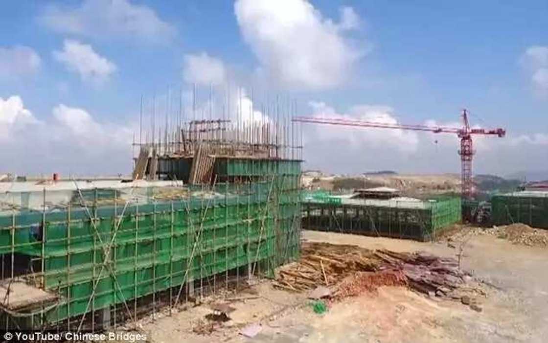 Incredible video shows Chinese workers building an airport at 5,900ft high after chopping off the top of a MOUNTAIN Incredible video shows Chinese workers building an airport at 5,900ft high after chopping off the top of a MOUNTAIN