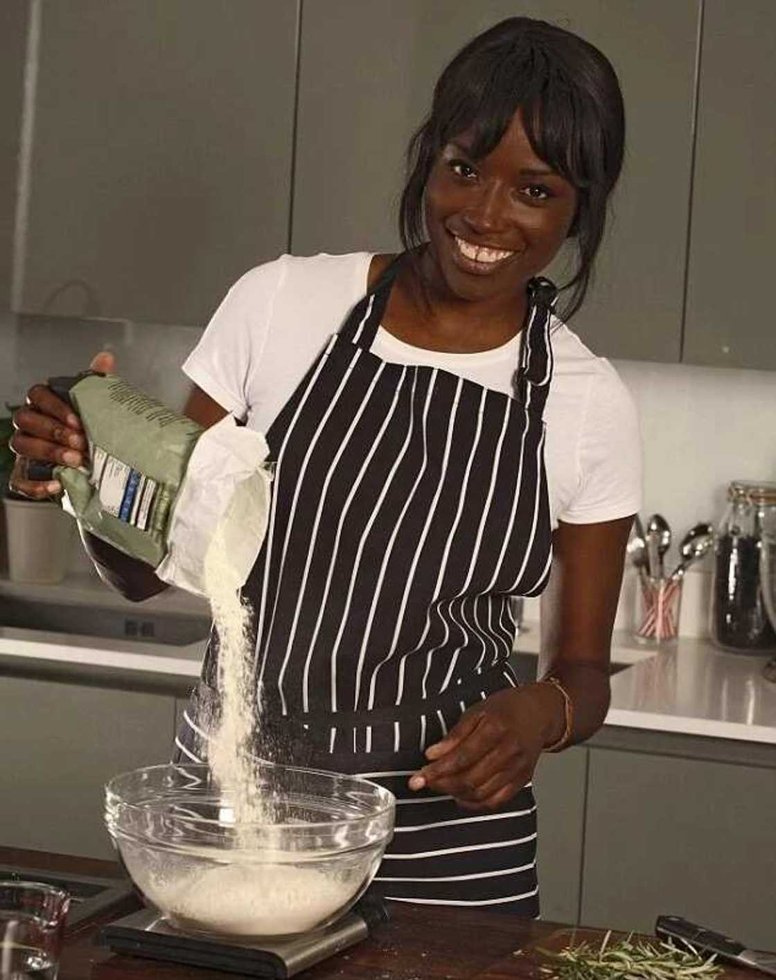 A lady is baking a cake