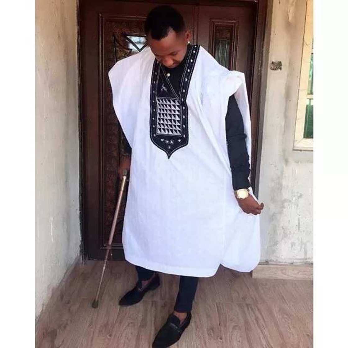 White Agbada style for guys with black embroidery White Agbada style for guys with black embroidery