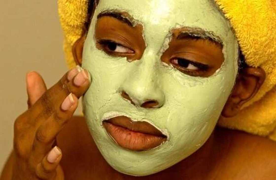 woman applying face mask woman applying face mask