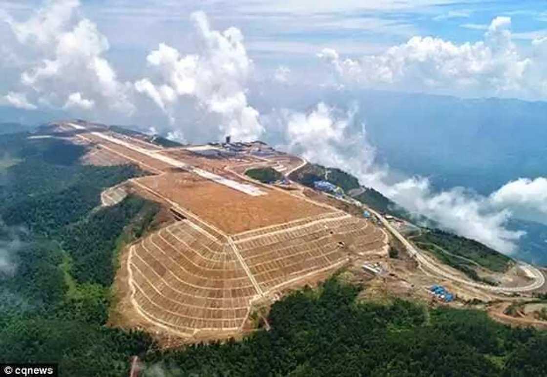 Incredible video shows Chinese workers building an airport at 5,900ft high after chopping off the top of a MOUNTAIN