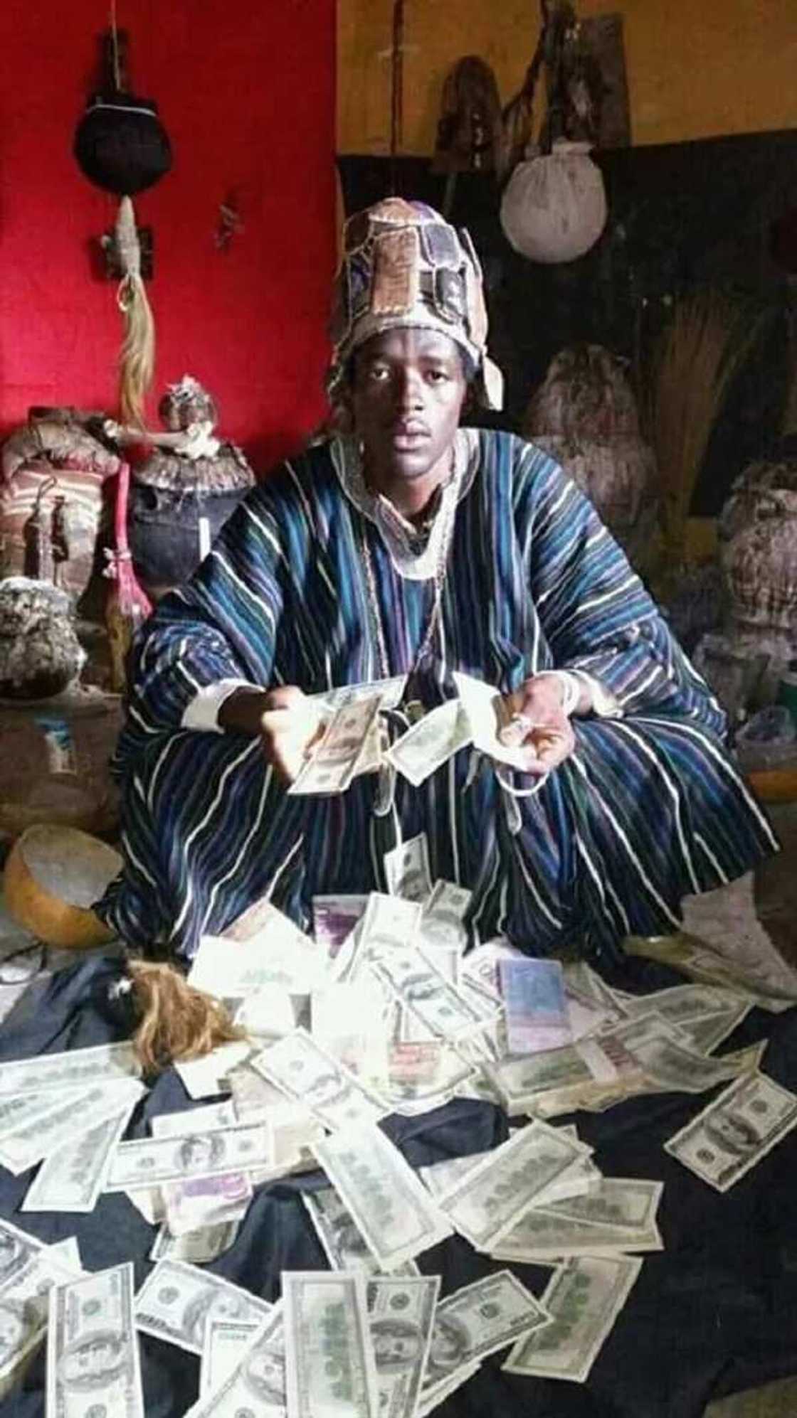 Ogun Native Doctor poses with dollars, claims he can make anyone rich