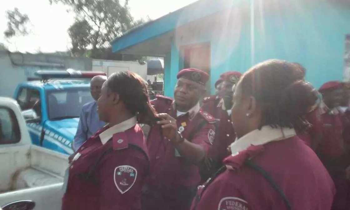 FRSC Sector Commander cutting off female officers' hairs FRSC Sector Commander cutting off female officers' hairs