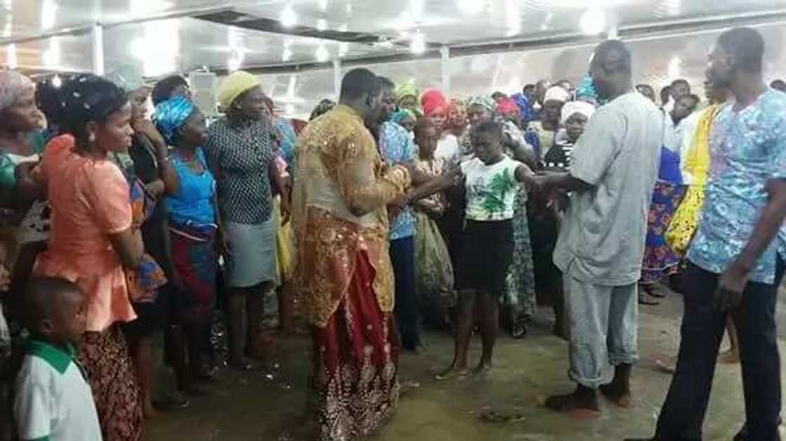 Nigerian prophet and his members worship in waterlogged church (photos) Nigerian prophet and his members worship in waterlogged church (photos)