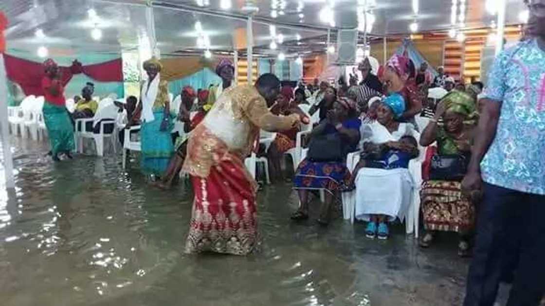 Nigerian prophet and his members worship in waterlogged church (photos) Nigerian prophet and his members worship in waterlogged church (photos)