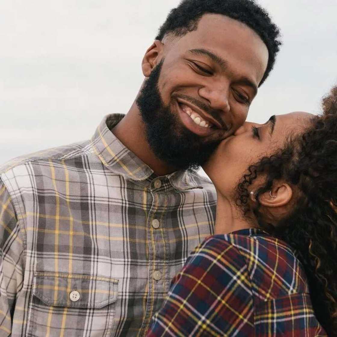 Woman kissing man