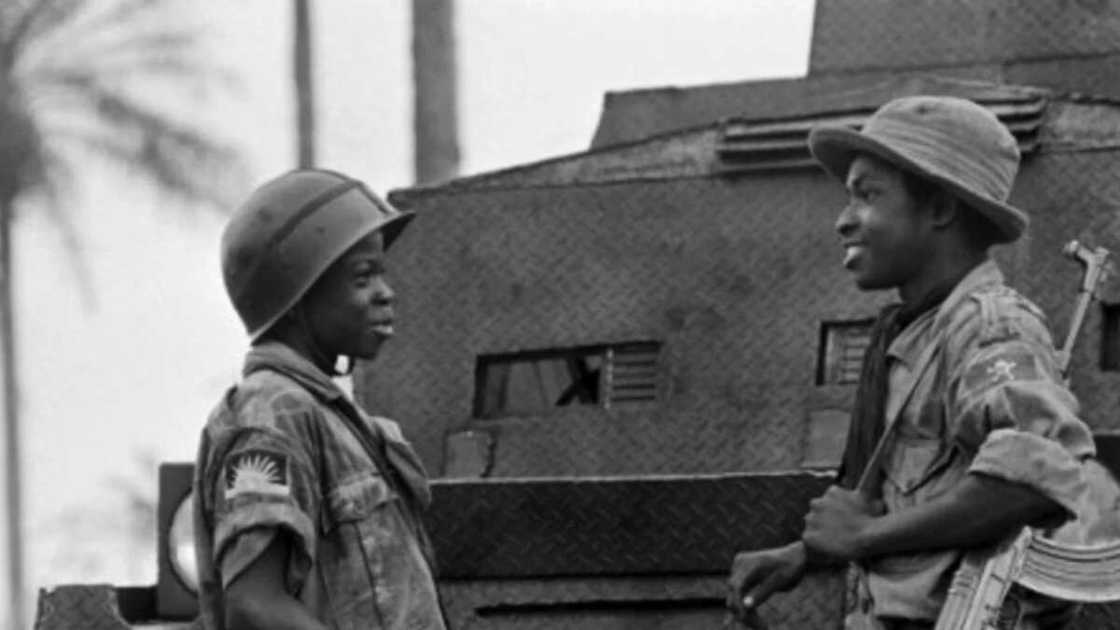 Moise, 14 (L) and Ferdinand, 16 (R), two children soldiers of the Biafran army during a discussion in Umuahia on August 31, 1968. AFP PHOTO/Francois Mazure